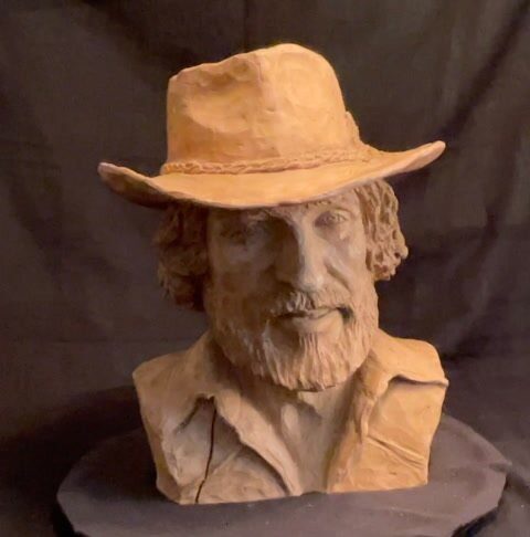Sculpted bust of a man in a cowboy hat