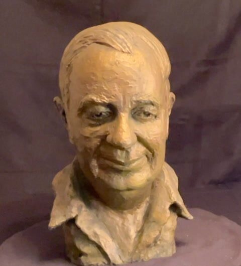 Sculpted bust of a smiling man