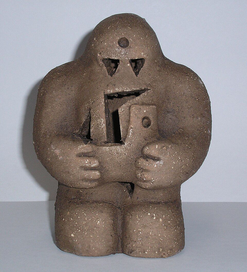 A squat brown clay golem figure with a slot in its chest